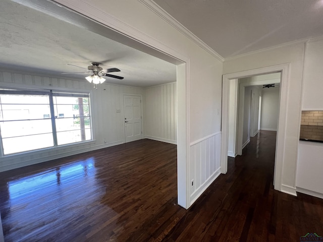 unfurnished room featuring a ceiling fan, crown molding, and dark wood-style floors
