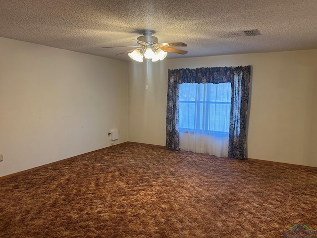 carpeted empty room featuring ceiling fan and a textured ceiling