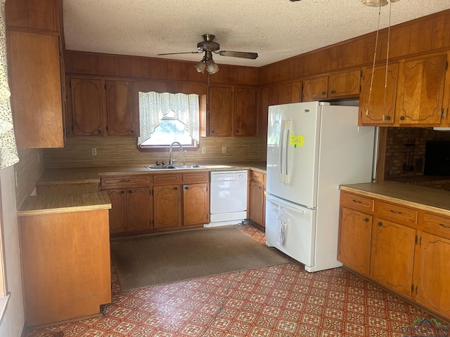 kitchen featuring a textured ceiling, white appliances, ceiling fan, and sink