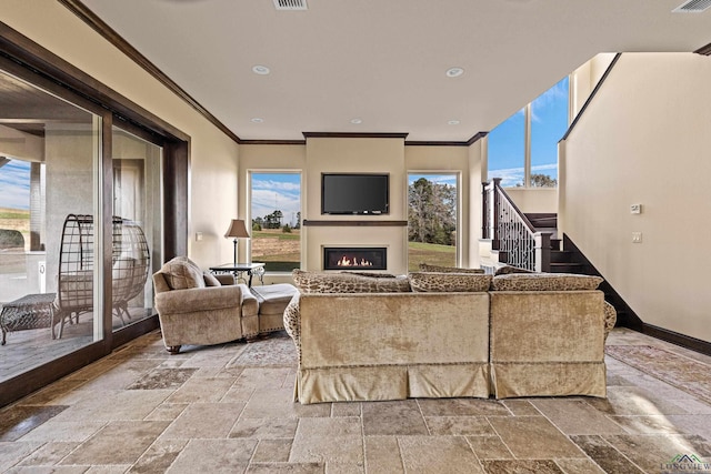 living room featuring crown molding and a fireplace