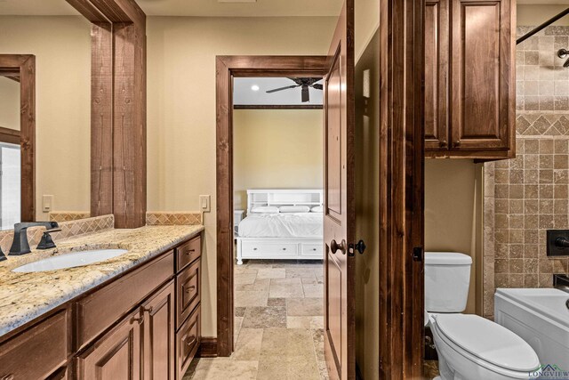 full bathroom featuring ceiling fan, shower / washtub combination, vanity, and toilet