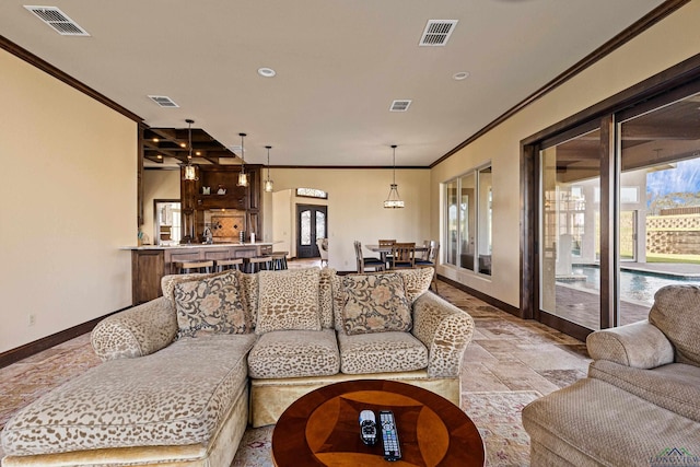 living room featuring a wealth of natural light, crown molding, and french doors