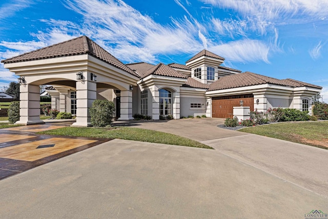 mediterranean / spanish house with a garage