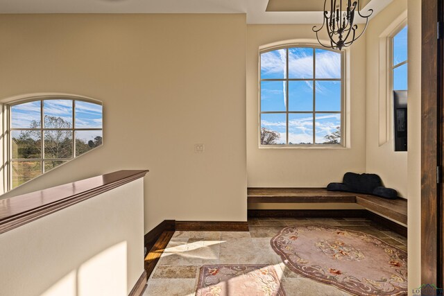 interior space with a wealth of natural light and an inviting chandelier