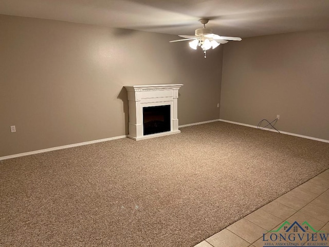 unfurnished living room featuring carpet floors and ceiling fan