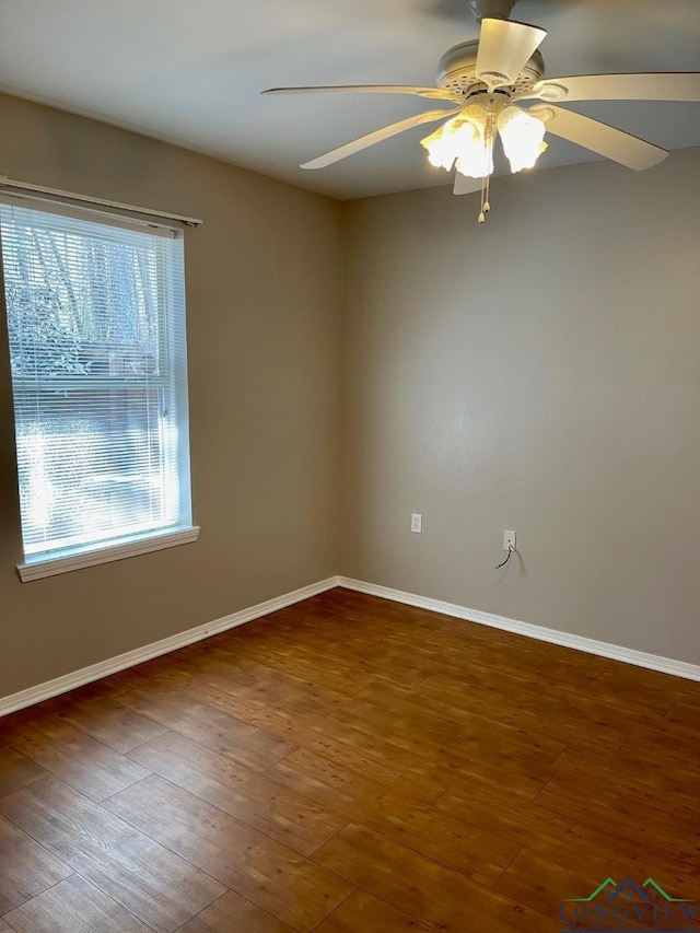 spare room with ceiling fan, plenty of natural light, and dark hardwood / wood-style floors