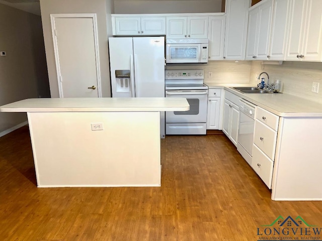 kitchen featuring sink, white appliances, decorative backsplash, and white cabinets