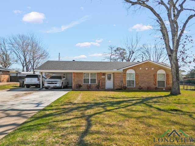 ranch-style home featuring brick siding, a front yard, fence, an attached carport, and driveway