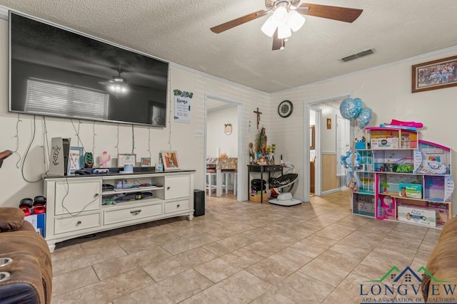 living room featuring a textured ceiling, ceiling fan, and visible vents