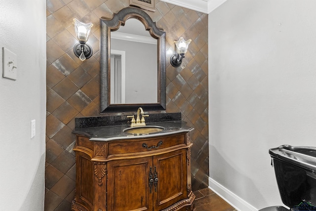 bathroom with tile patterned floors, toilet, vanity, and ornamental molding