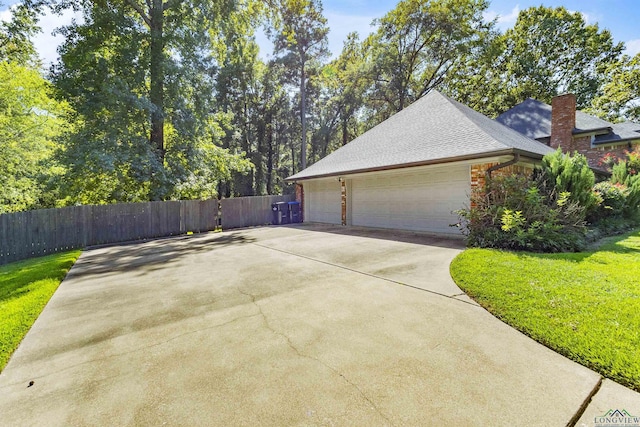 exterior space featuring a garage and a yard