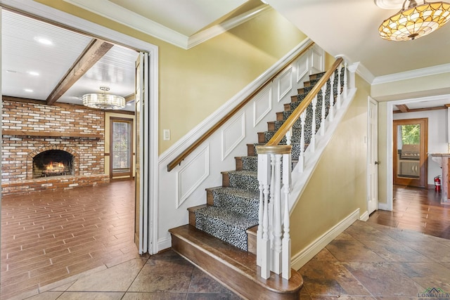 stairs featuring a fireplace and ornamental molding