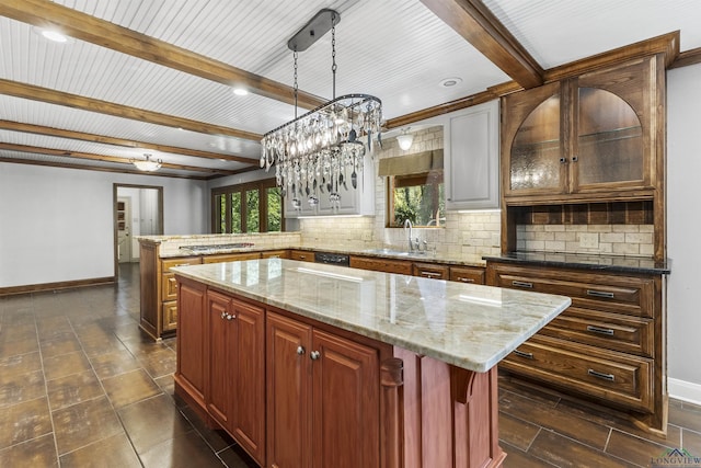 kitchen featuring kitchen peninsula, a center island, tasteful backsplash, and hanging light fixtures