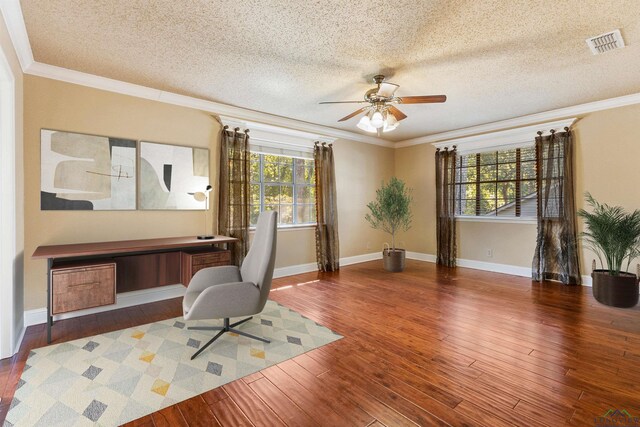 unfurnished office with a textured ceiling, ceiling fan, and ornamental molding