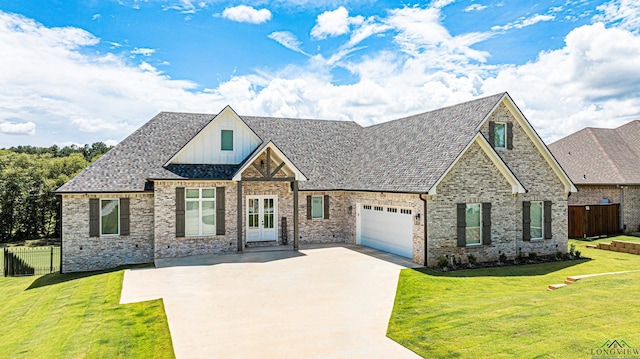 view of front of house with a front yard, french doors, and a garage