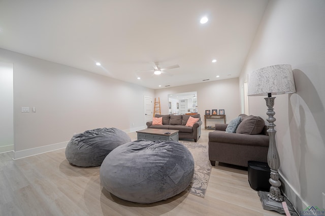 living room with ceiling fan and light hardwood / wood-style floors