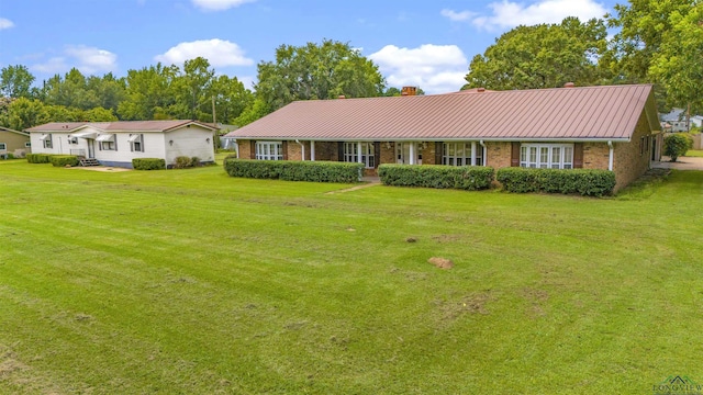 ranch-style home with a front lawn