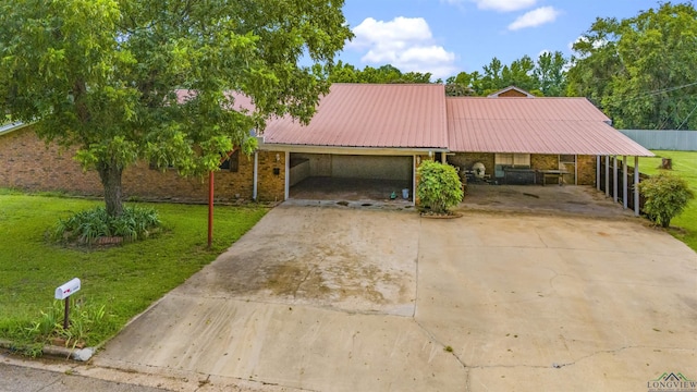 single story home with a front yard and a carport