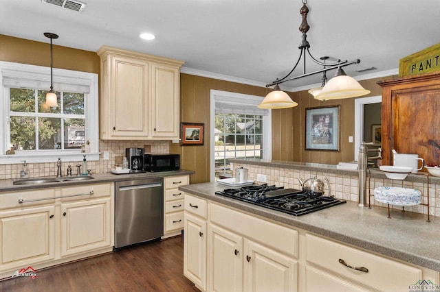 kitchen featuring decorative backsplash, sink, black appliances, cream cabinets, and hanging light fixtures