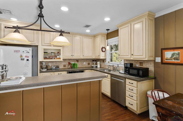 kitchen featuring sink, stainless steel dishwasher, cream cabinets, white fridge, and decorative light fixtures