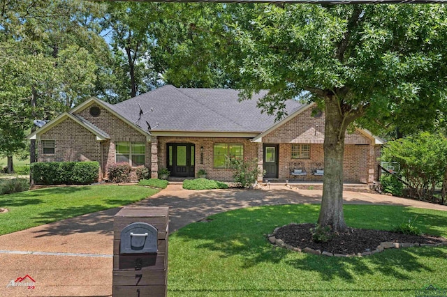 3718 Ben Hogan Dr, Longview, TX 75605 - view of front of home featuring a front yard, brick siding, and a shingled roof