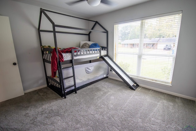 carpeted bedroom with ceiling fan and multiple windows