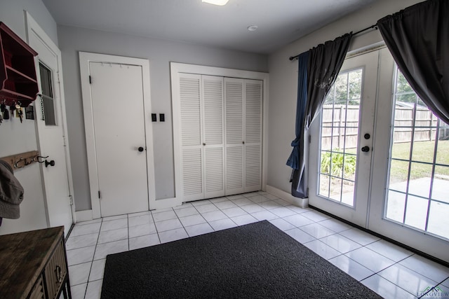 doorway featuring french doors and light tile patterned flooring