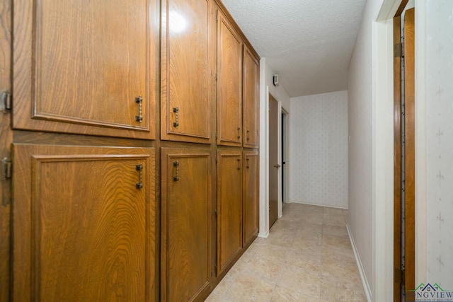 corridor featuring a textured ceiling