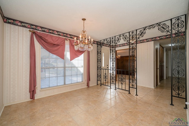 unfurnished dining area featuring an inviting chandelier