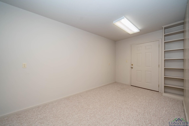 unfurnished room featuring light colored carpet