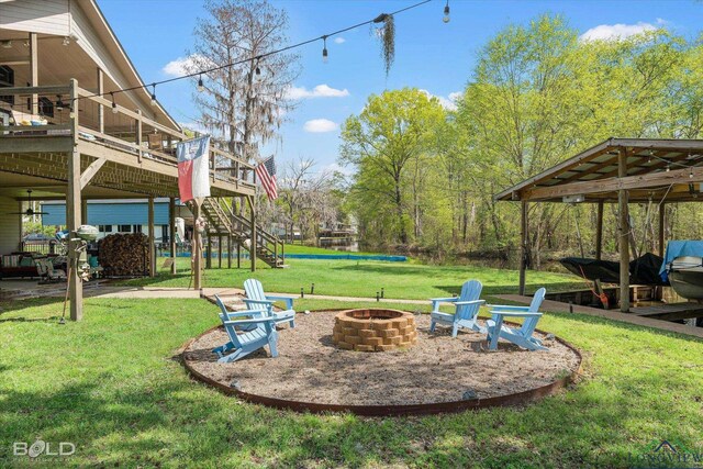 view of yard with a fire pit and a wooden deck