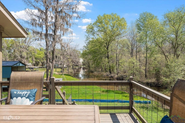 wooden deck featuring a water view