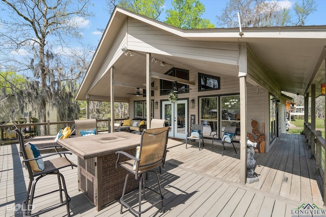 wooden terrace featuring ceiling fan and french doors