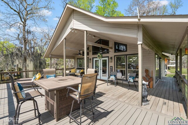 wooden terrace featuring ceiling fan and french doors