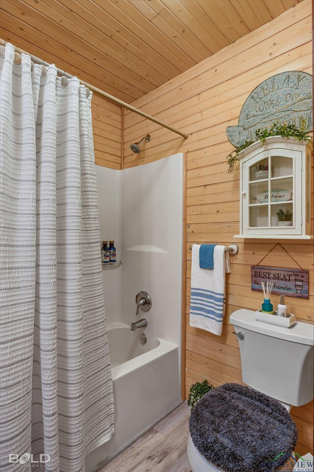 bathroom featuring shower / bath combo, wood-type flooring, wooden ceiling, and wooden walls