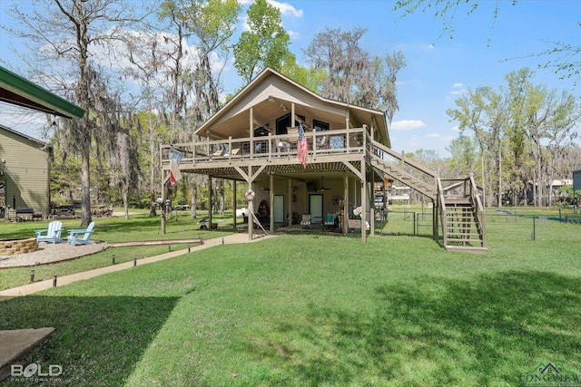 back of house with a lawn and a wooden deck