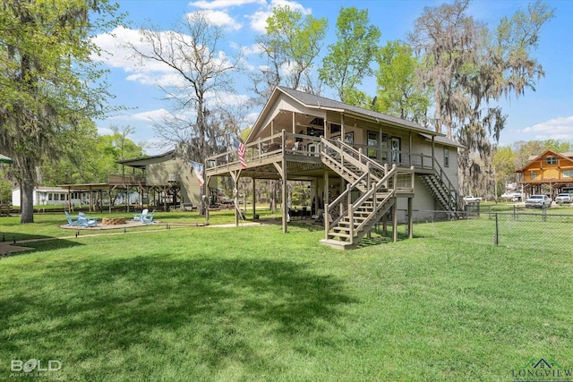 rear view of property with a lawn and a deck