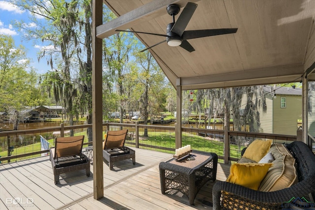 sunroom featuring a water view and ceiling fan