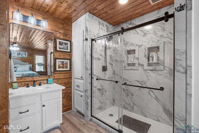 bathroom with wood-type flooring, a shower with shower door, wooden ceiling, and sink