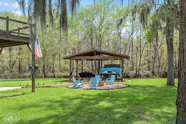 view of yard with an outdoor fire pit and a deck