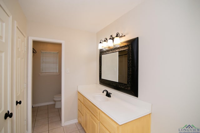 bathroom with tile patterned floors, vanity, and toilet