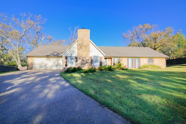 view of front of home with a garage and a front yard