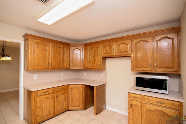 kitchen with pendant lighting, a notable chandelier, and light tile patterned floors