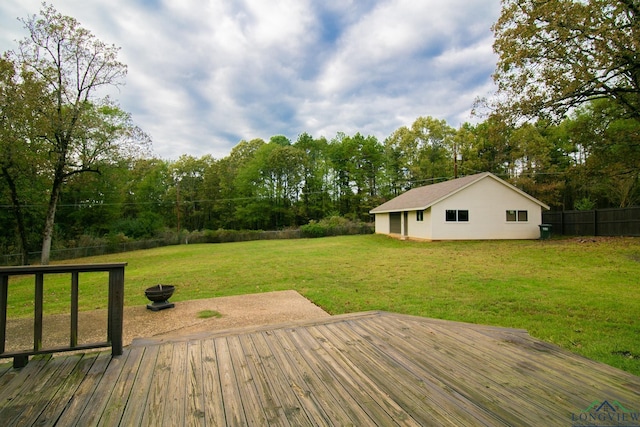 wooden deck with an outbuilding and a yard