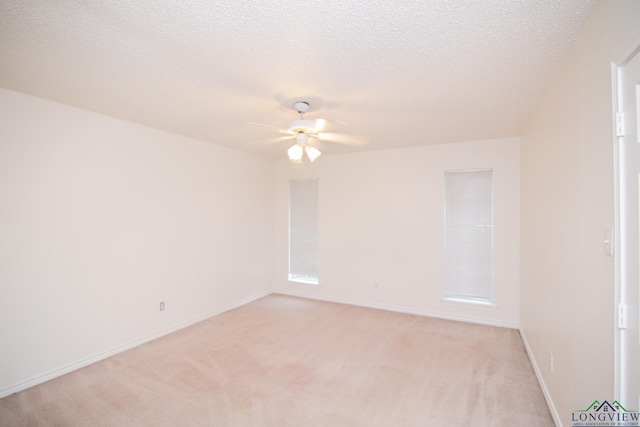 carpeted spare room with ceiling fan and a textured ceiling