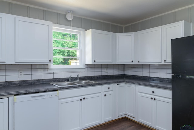 kitchen with white cabinetry, black fridge, and white dishwasher