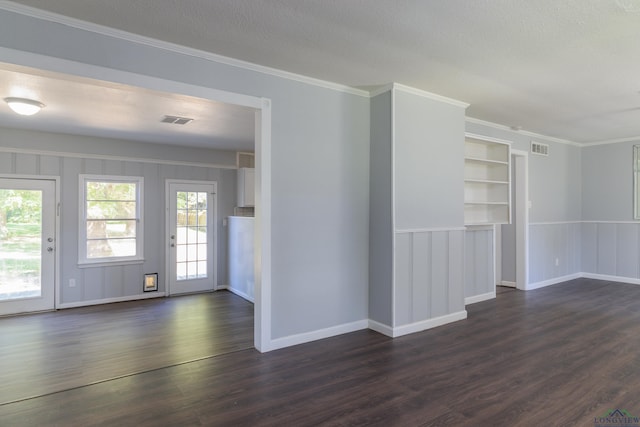 unfurnished room featuring crown molding, a healthy amount of sunlight, and dark hardwood / wood-style floors