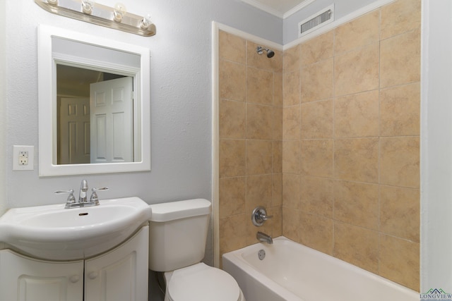 full bathroom featuring tiled shower / bath combo, toilet, crown molding, and vanity