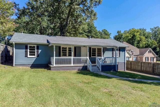 ranch-style house featuring a front lawn and covered porch