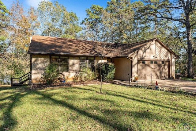 view of front of house featuring a garage and a front lawn